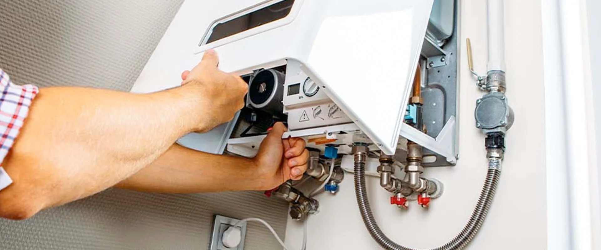 Plumber repairing a residential water heater in San Jose, CA